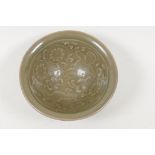 A Chinese Song style olive celadon bowl embossed with children and flowers, 4" diameter