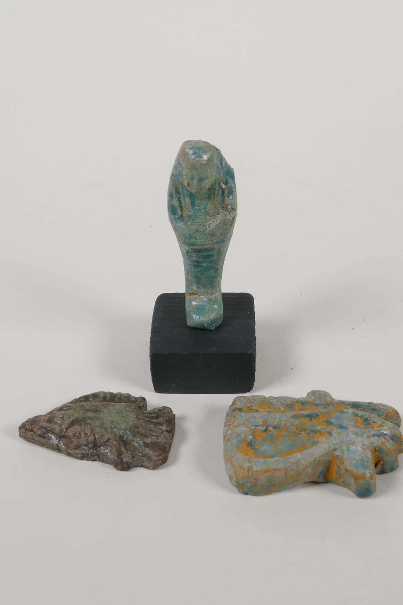 An Egyptian turquoise glazed faience shabti, a turquoise glazed pottery token in the form of the Eye