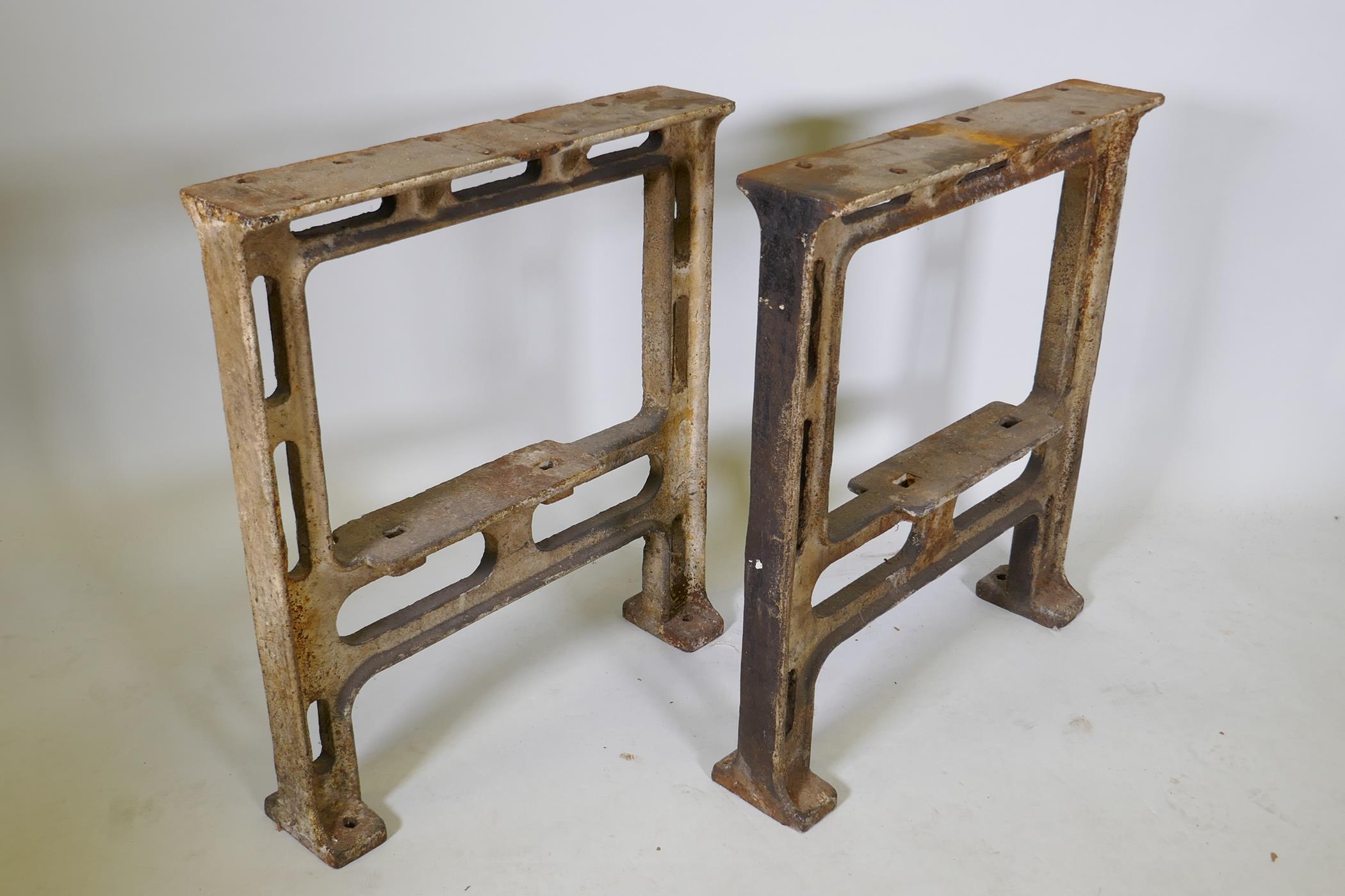 A pair of industrial cast iron table legs, 25½" x 5", 28½" high