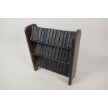 A miniature three tier oak bookcase with 40 volumes of The Works of Shakespeare, printed by Allied
