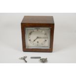 An Art Deco inlaid oak cased Westminster Chimes mantel clock with silvered dial and Arabic numerals,