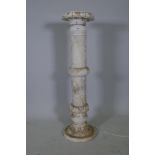 An alabaster jardiniere stand with carved decoration, 39" high