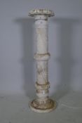 An alabaster jardiniere stand with carved decoration, 39" high