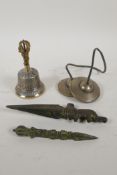 A pair of Tibetan bronze cymbals and a bell with a vajra handle, and two cast iron miniature phurba,