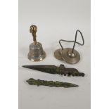 A pair of Tibetan bronze cymbals and a bell with a vajra handle, and two cast iron miniature phurba,