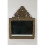 A Dutch brass wall mirror with repousse floral frieze and landscape scene with windmills, 13" x 16½"