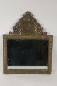 A Dutch brass wall mirror with repousse floral frieze and landscape scene with windmills, 13" x 16½"