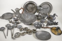 A quantity of antique and oriental pewter wares including oil lamp, quaich, tappet, spoons etc