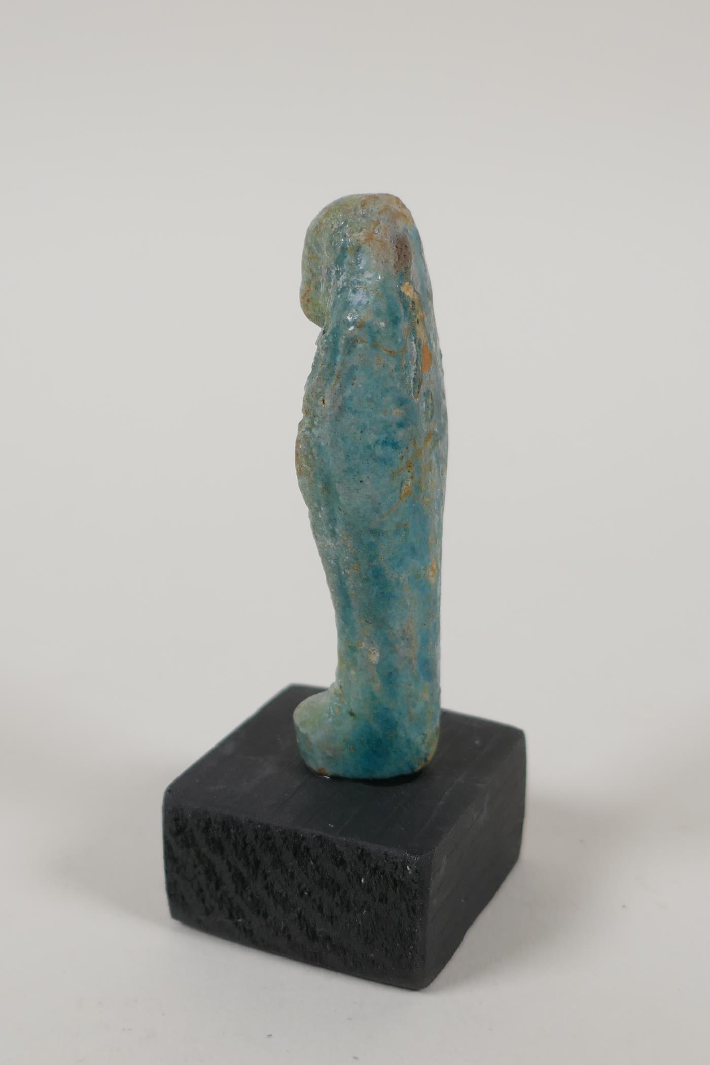 An Egyptian turquoise glazed faience shabti, a turquoise glazed pottery token in the form of the Eye - Image 4 of 6