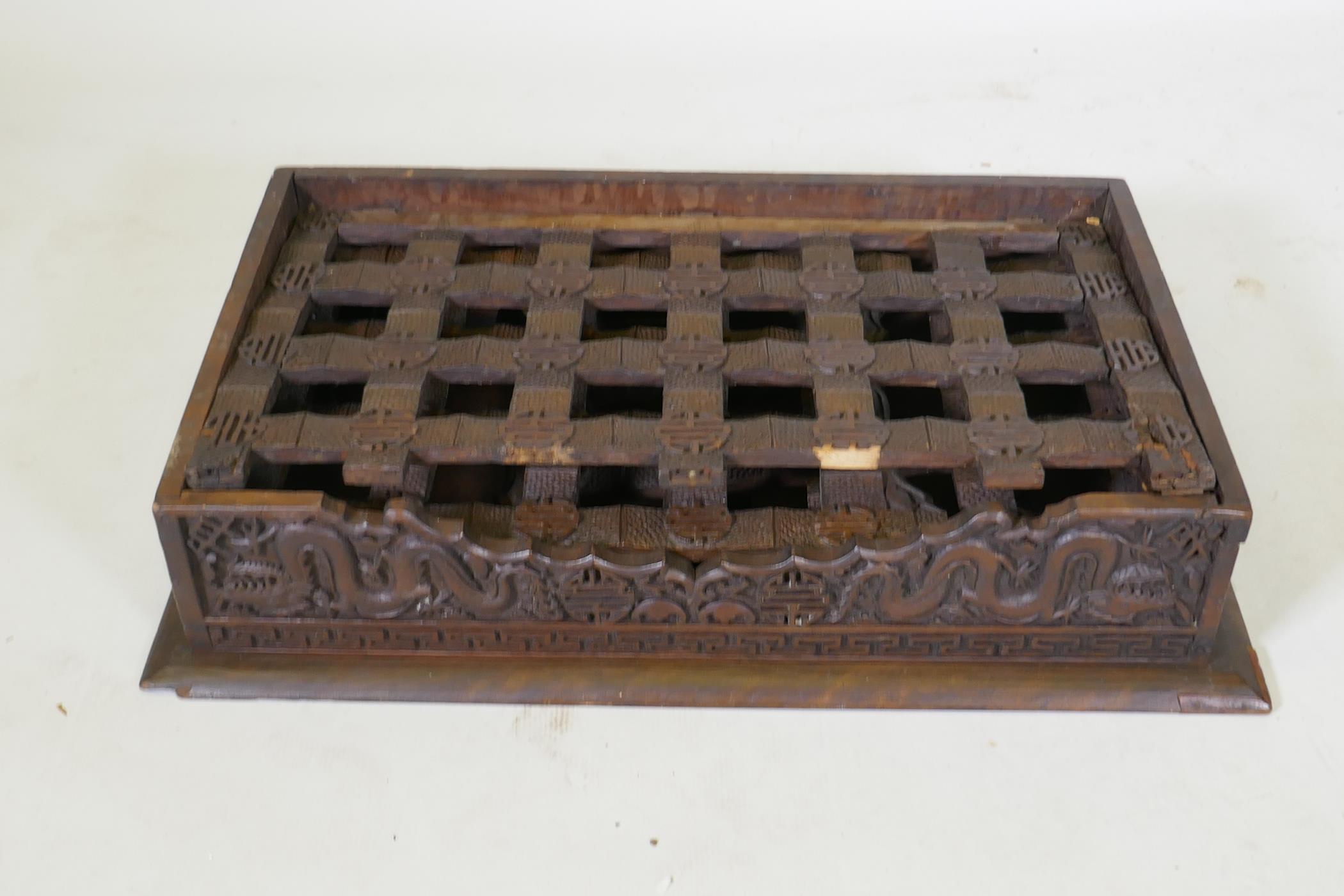 A C19th Chinese carved hardwood travel desk with a pierced folding base, decorated with dragons - Image 7 of 7