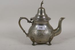 A white metal coffee pot with incised floral decoration, stamped T.A. to base with Arabic script,