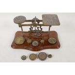 A set of brass and mahogany postal scales with two sets of weights, 9" long