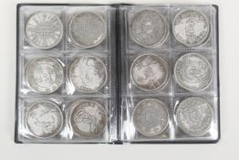 A wallet of sixty Chinese facsimile (replica) white metal coins/tokens, 1½" diameter
