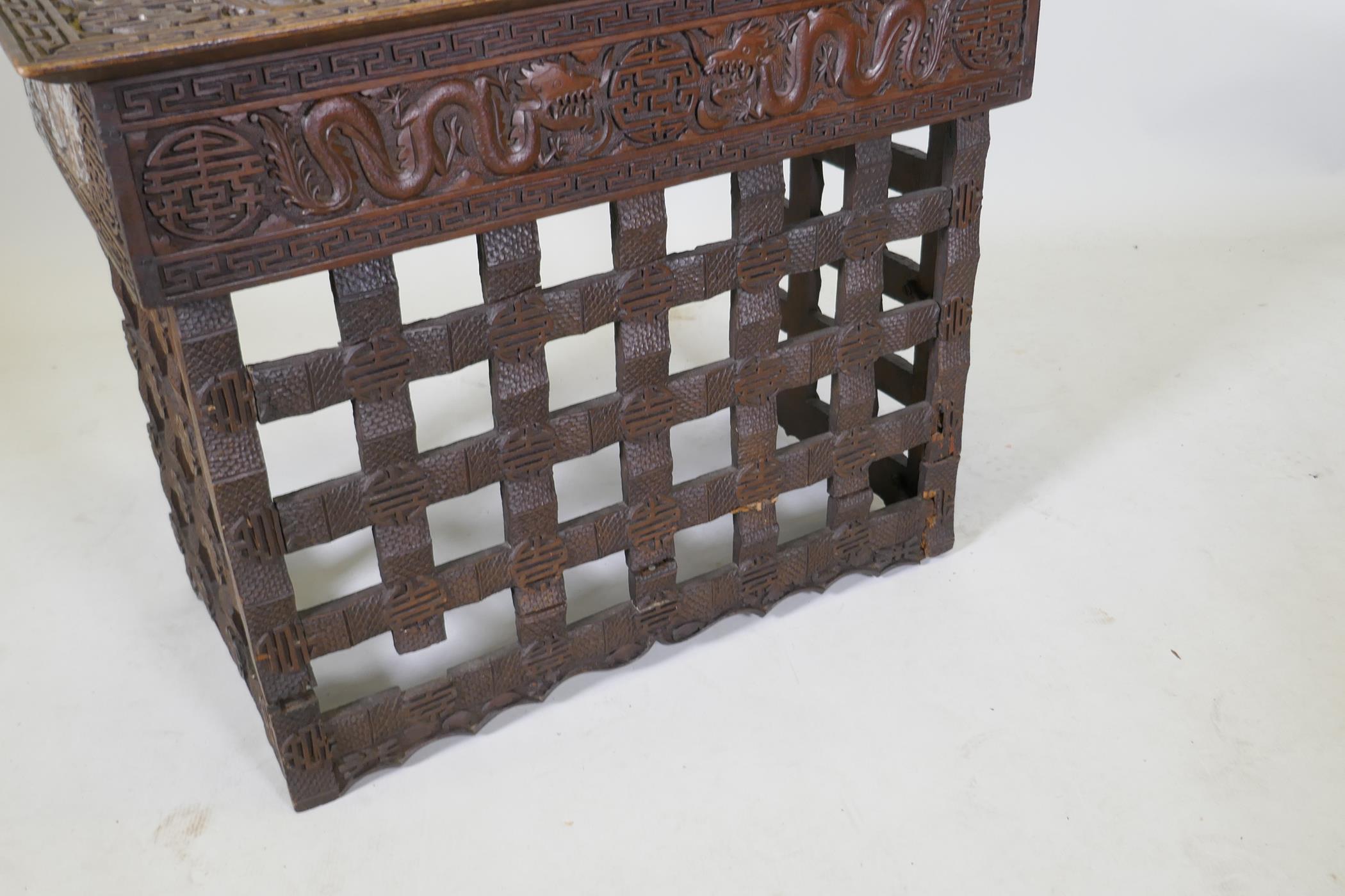 A C19th Chinese carved hardwood travel desk with a pierced folding base, decorated with dragons - Image 4 of 7