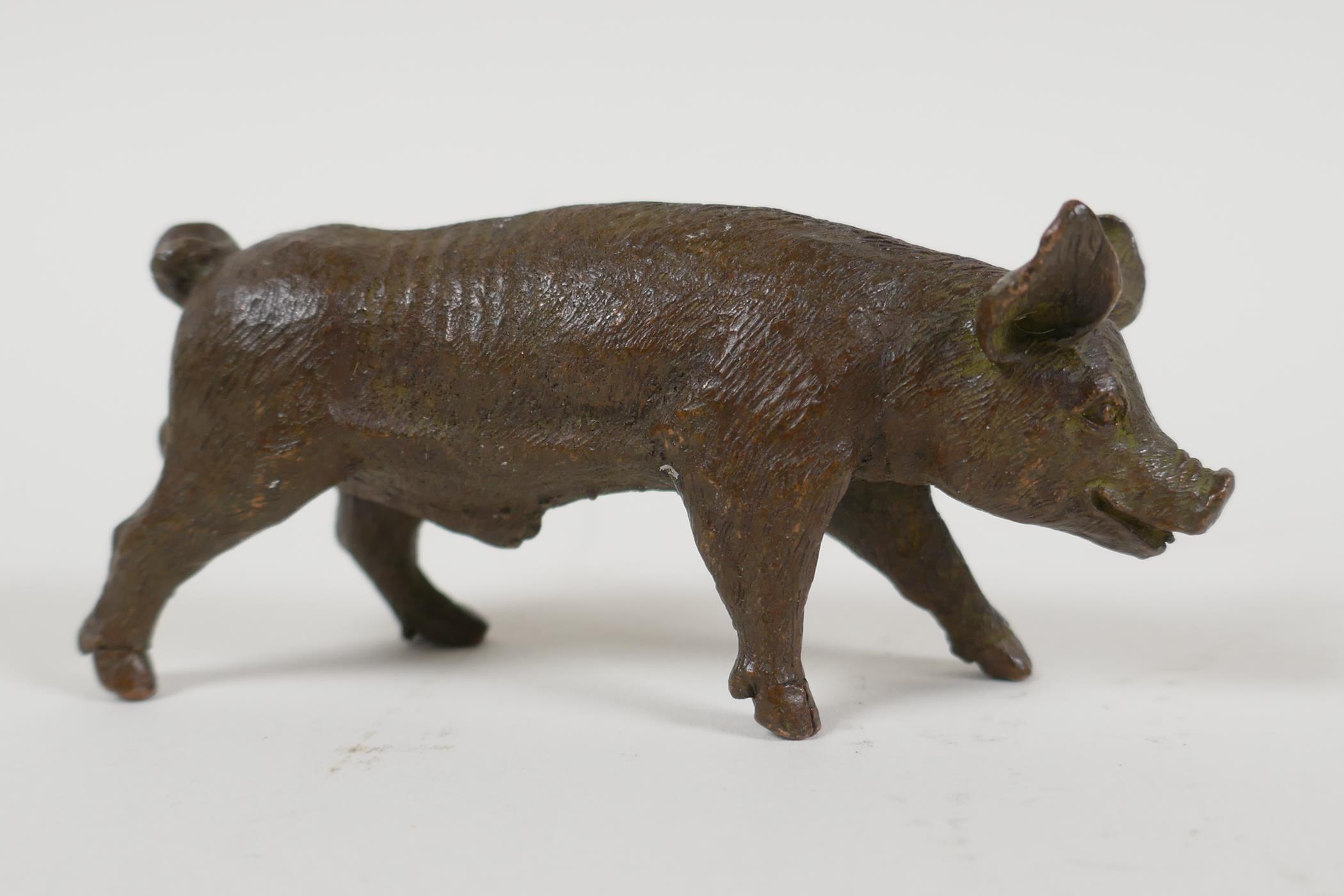 A Japanese bronze okimono in the form of a pig, 3½" long