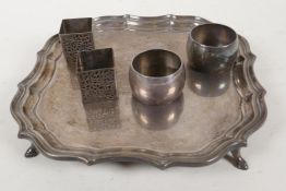 A hallmarked silver card tray with gadrooned rim, on four hoof feet, and two pairs of silver