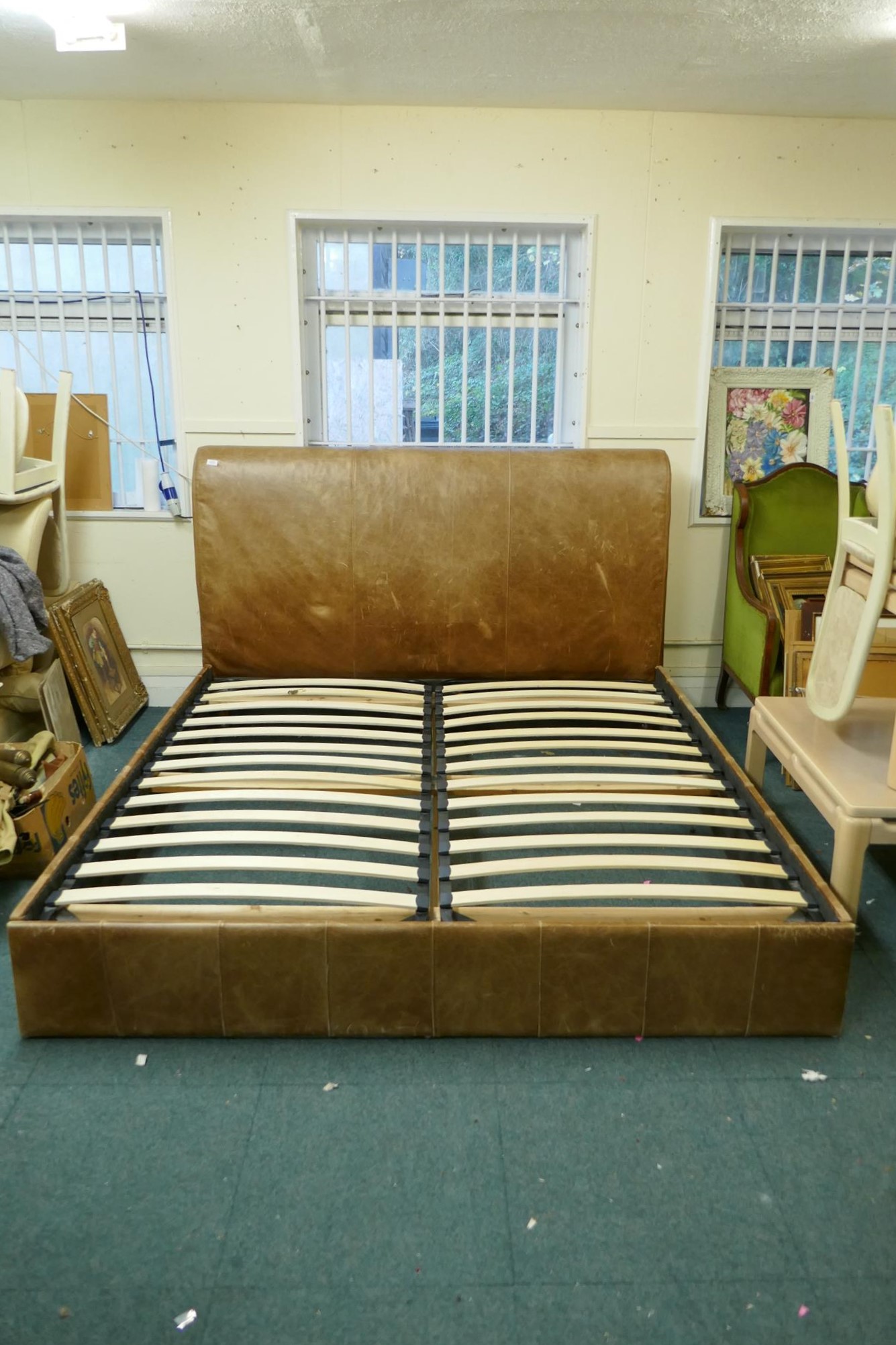 A leather upholstered double bed, 74" x 46" x 90"