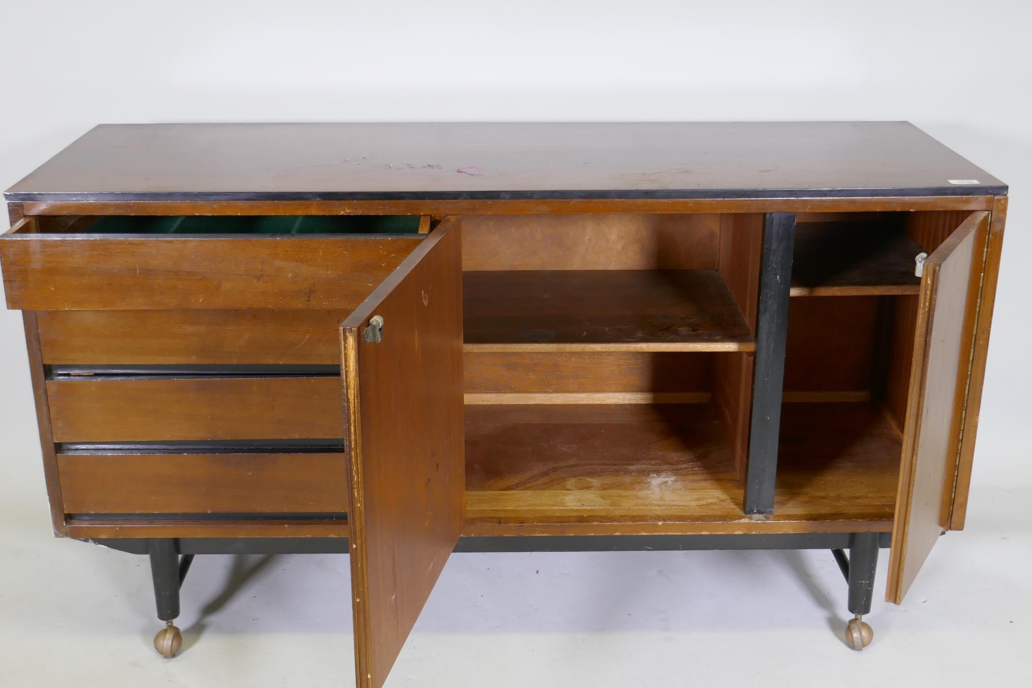 A mid-century mahogany sideboard with ebonised detail, comprising two cupboards and four drawers, - Image 4 of 6