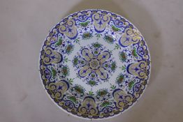 A large continental faience ceramic charger with oriental style decoration, 24" diameter
