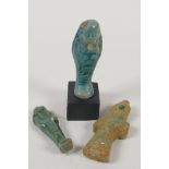 An Egyptian turquoise glazed faience shabti, and another smaller, together with a turquoise glazed