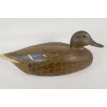 A painted wood decoy duck in naturalistic colours with glass eyes, signed to base R. Jeeves 1977,