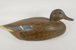 A painted wood decoy duck in naturalistic colours with glass eyes, signed to base R. Jeeves 1977,