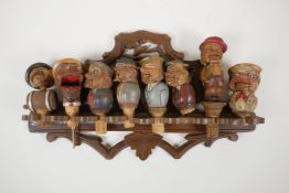 Eight carved and painted Black Forest figural caricature bottle stoppers/pourers, most with