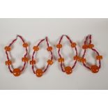 Four glass and faux amber graduated beaded necklaces, 18" long