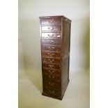 An early C20th stained and polished beech wood flight of twelve drawers, 16½" x 28" x 60"