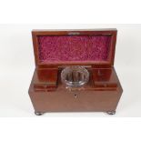 A C19th mahogany two compartment sarcophagus shaped tea caddy with original glass mixing bowl,