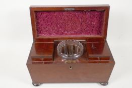 A C19th mahogany two compartment sarcophagus shaped tea caddy with original glass mixing bowl,