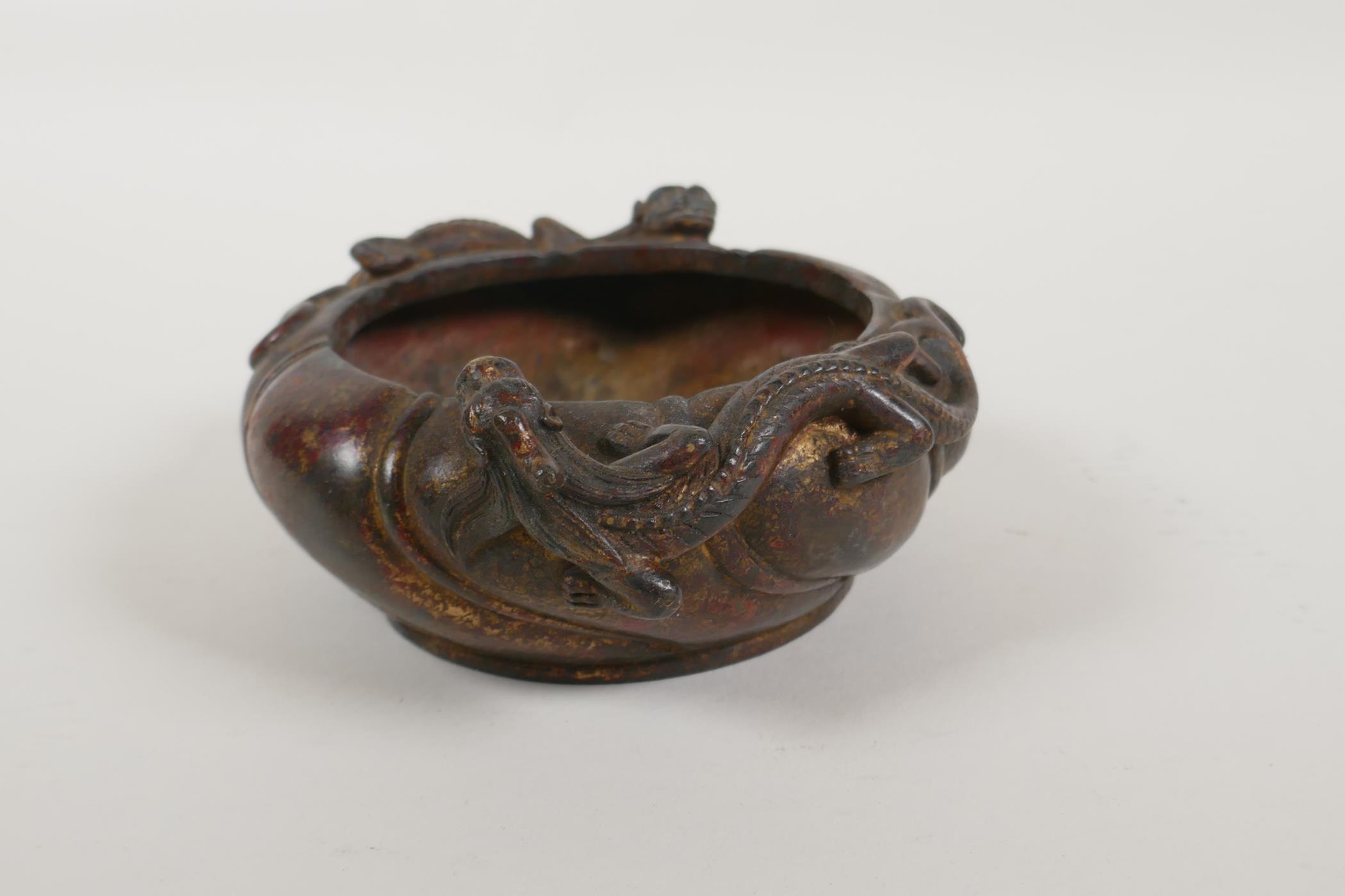 A Chinese gilt bronze censer of lobed form, with raised twin dragon decoration, impressed mark to - Image 2 of 4