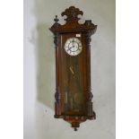 A C19th Vienna wall clock, the enamel dial with Roman numerals and a subsidiary second dial, 47"