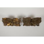 A pair of Chinese carved and gilded wood fo dog mounts, 8½" x 4"