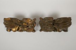 A pair of Chinese carved and gilded wood fo dog mounts, 8½" x 4"