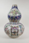 A Chinese polychrome enamelled porcelain double gourd vase, with decorative panels depicting figures
