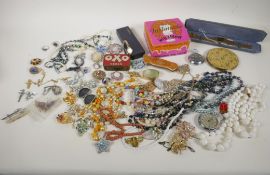 A quantity of costume jewellery and watches, in a tin