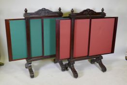 A pair of Victorian mahogany fire screens with sliding extendable panels, raised on scroll end