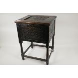 A C19th peg jointed oak workbox stool with chip carved rosette decoration on turned supports, 18"