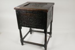 A C19th peg jointed oak workbox stool with chip carved rosette decoration on turned supports, 18"