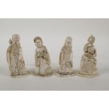 A set of four Japanese Meiji period ivory okimono carved in the form of deities, signed to base, 3½"