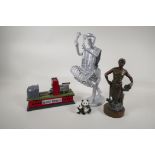 A bronzed spelter figure of a foundry worker, and iron trick train money box, a painted metal figure
