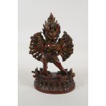 A Sino Tibetan bronze figure of a many armed wrathful deity with a coppered and gilt patina, 7" high