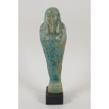 An Egyptian turquoise glazed faience shabti, 7½" high