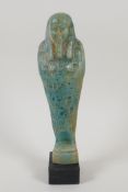 An Egyptian turquoise glazed faience shabti, 7½" high
