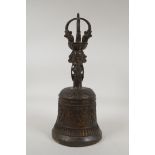 A Tibetan gilt bronze ceremonial bell, the handle with Buddha head and vajra decoration, 13½" high