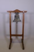 Antique bronze bell, mounted in a pine frame, 45" x 26" x 25"