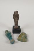 Two Egyptian glazed faience shabtis, together with a turquoise glazed faience shabti head, largest