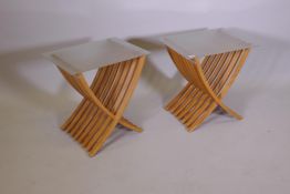 A pair of contemporary beechwood side tables with glass tops and folding bases, 16" x 21" x 21"