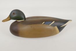 A wood decoy duck painted as a drake, signed and dated 1977, 16" long